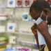 In this Feb. 6, 2020, photo, a man tries on a face mask at a pharmacy in Kitwe, Zambia. Photo/Emmanuel Mwiche)