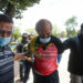 Ruben Ecleo is escorted by officers outside police regional headquarters in Manila