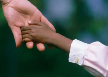 File photo of an adult holding a child's hand