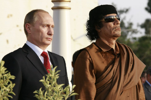 Vladimir Putin and late Muammar Gaddafi