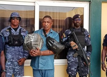 The suspect Aremu Timothy Adegboyega with custom officers