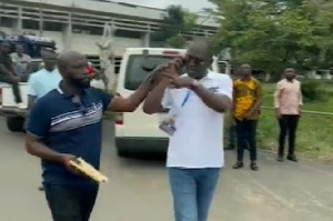 Kennedy Agyapong being restrained by one his associates
