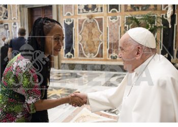 Samia Nkrumah in a handshake with Pope Francis