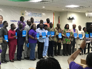 Some dignitaries display the strategy document during the launch